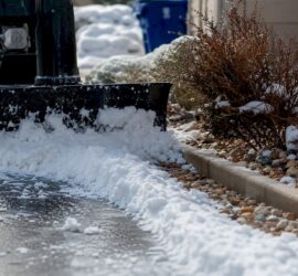 Compact snowblower clearing small driveway