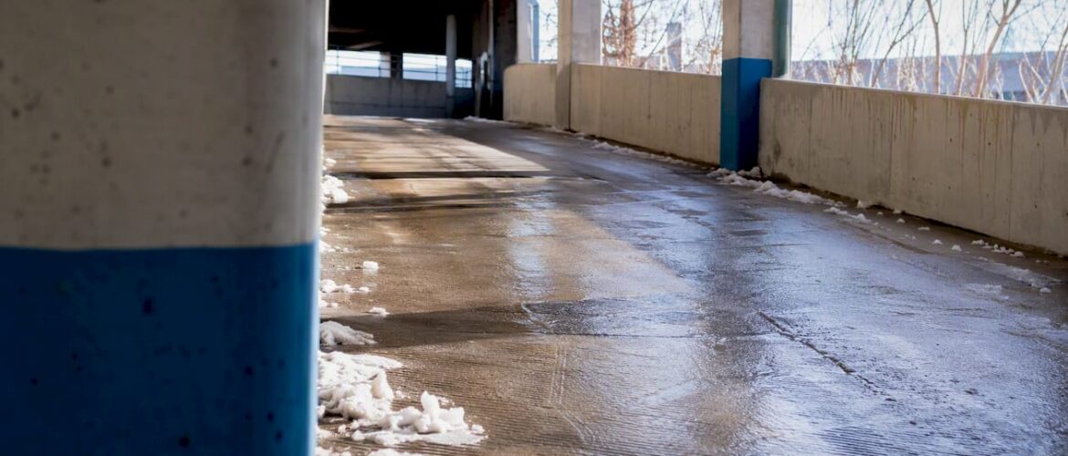 Icy, textured parking garage ramp surface