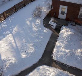 Aerial view of snow piles placed to keep driveway accessible