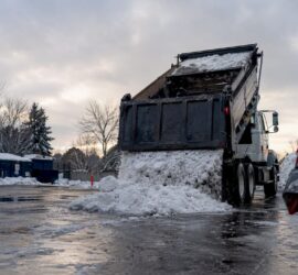 Snow hauling truck unloading snow in Denver