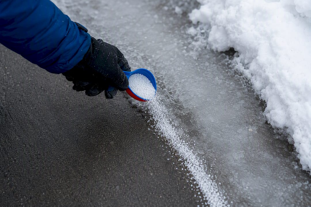 Ice melt applied beside cleared driveway
