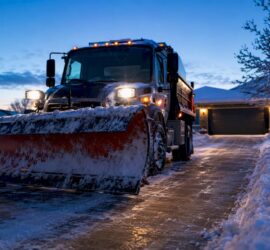 Snowplow clearing a Denver driveway