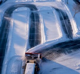 Snowplow creating organized parking lot lanes